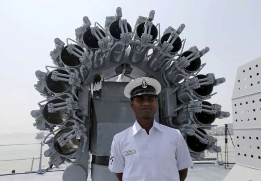 File: An Indian Navy personnel looks on as he stands in front of the rocket launcher system mounted on the deck of the newly built INS Kochi, a guided missile destroyer, during a media tour at the naval dockyard in Mumbai, India September 28, 2015. The warship which will be commissioned on Wednesday is the second ship in the Indian Navy to have multi-function surveillance and threat alert radar to provide information about targets for a long-range surface-to-air missile system, according to a media release issued by the Indian Navy.