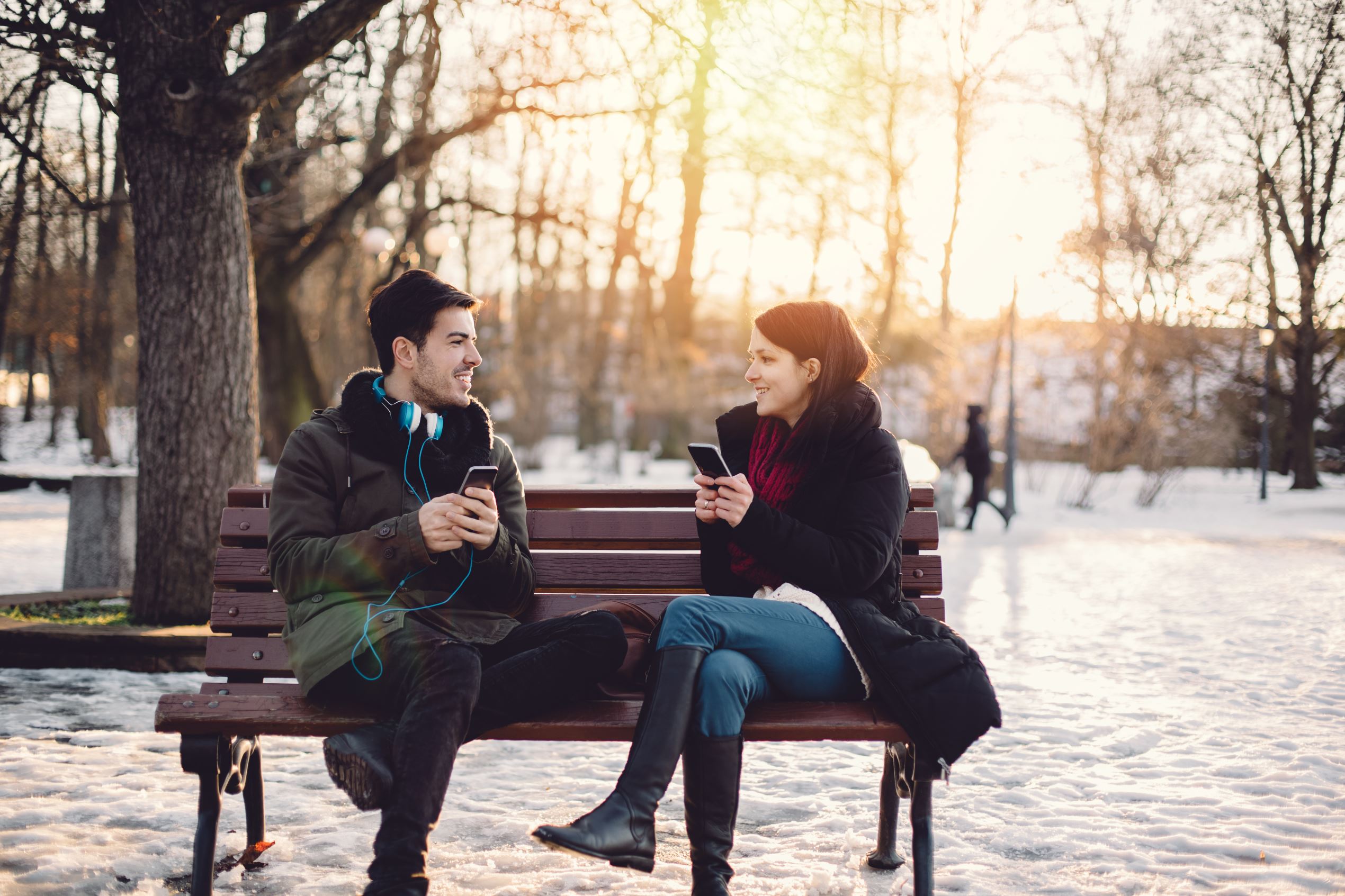 Slide 1 of 25: Happy couple texting on smartphones