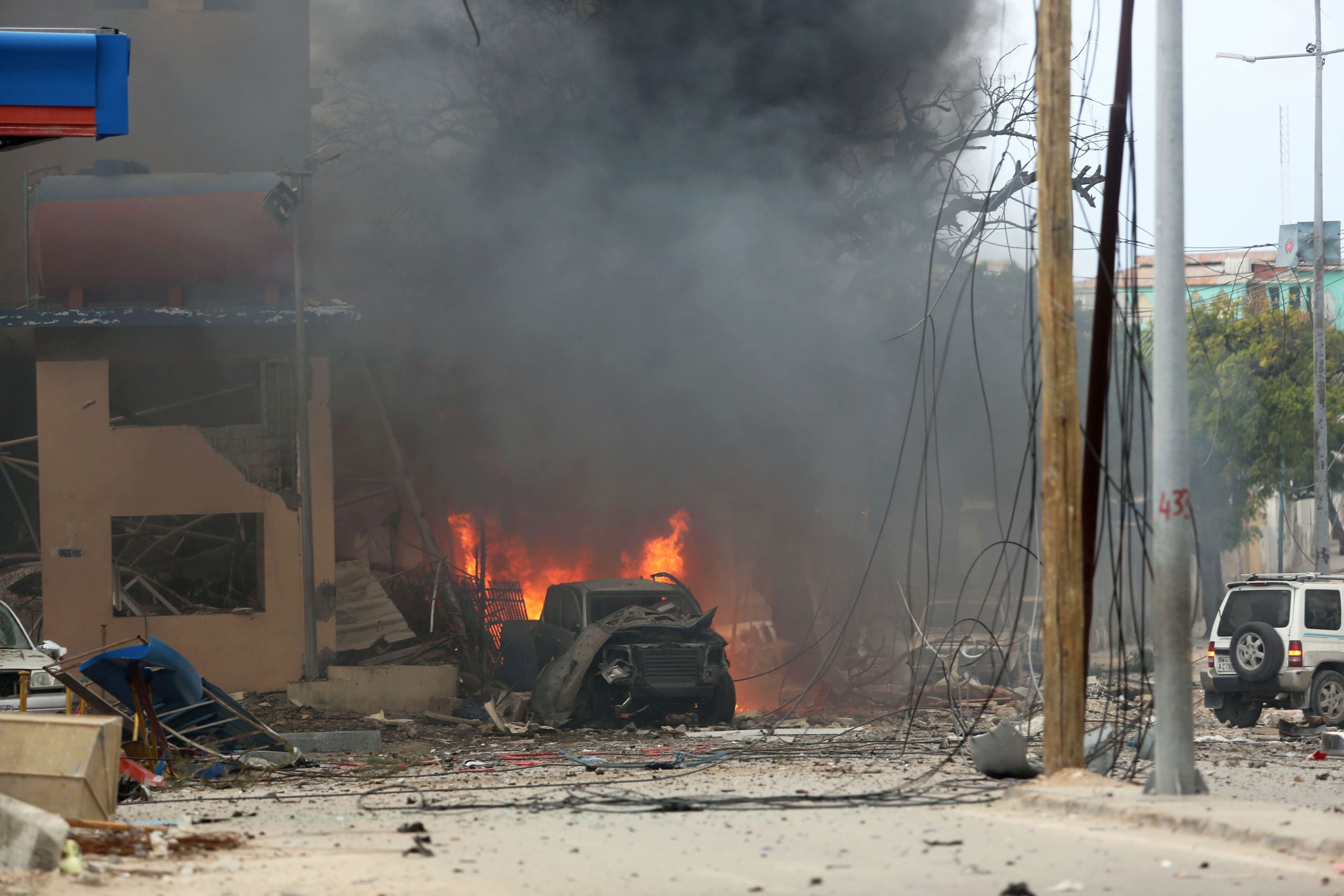 Slide 1 of 10: A vehicle burns at the scene of a suicide bomb attack outside Nasahablood hotel in Somalia's capital Mogadishu, June 25, 2016. REUTERS/Feisal