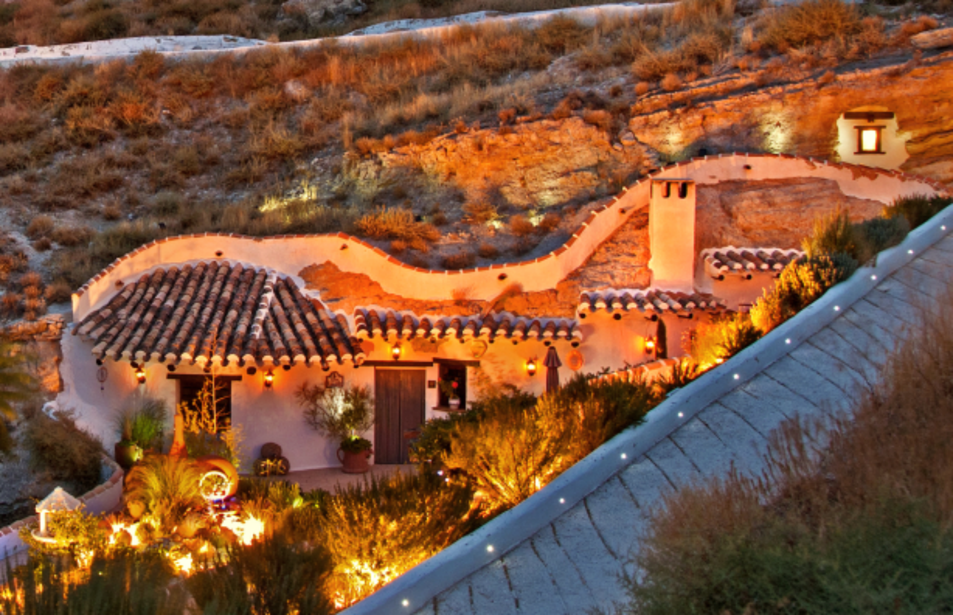 Slide 31 of 54: Over in Spain, this dwelling is built directly into the side of a hill in Galera. As you can see, it's set in a pretty peaceful location.