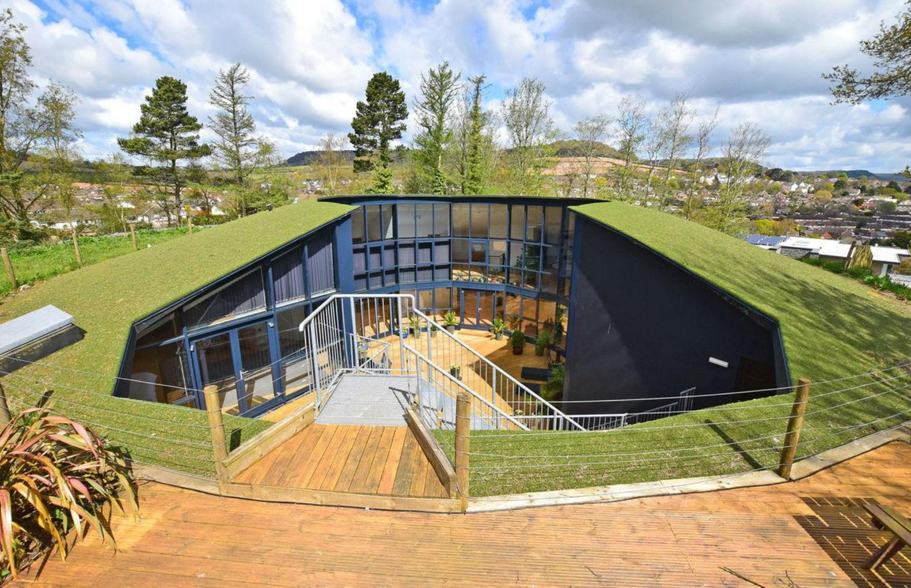 Slide 23 of 54: This five-bedroom house is a conversion of a former water reservoir in Sidmouth, south-west England, with floods of light coming through the huge walls of glass.