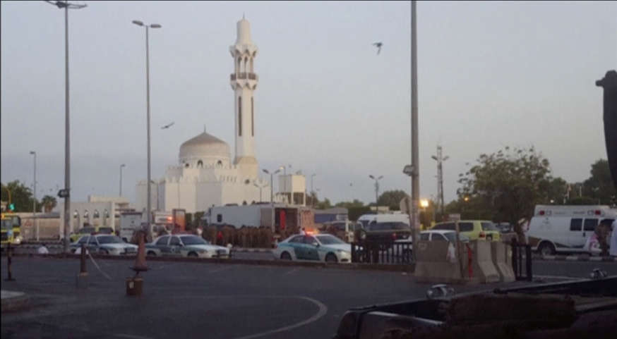 General view of security personnel in front of a mosque as police stage a second controlled explosion, after a suicide bomber was killed and two other people wounded in a blast near the U.S. consulate in Jeddah, Saudi Arabia, in this still frame taken fr