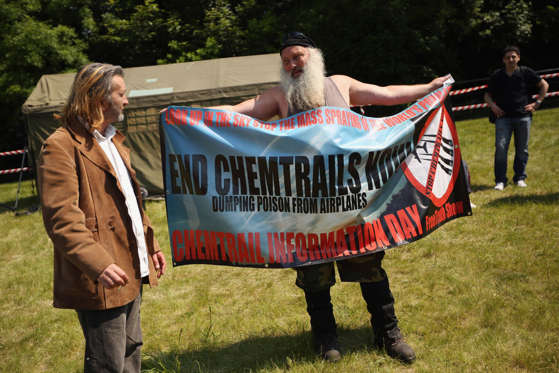 Slide 17 of 25: WATFORD, ENGLAND - JUNE 06: A man demonstrates against 'Chemtrails' in a protester encampment outside The Grove hotel, which is hosting the annual Bilderberg conference, on June 6, 2013 in Watford, England. The traditionally secretive conference, which has taken place since 1954, is expected to be attended by politicians, bank bosses, businessman and European royalty. (Photo by Oli Scarff/Getty Images)