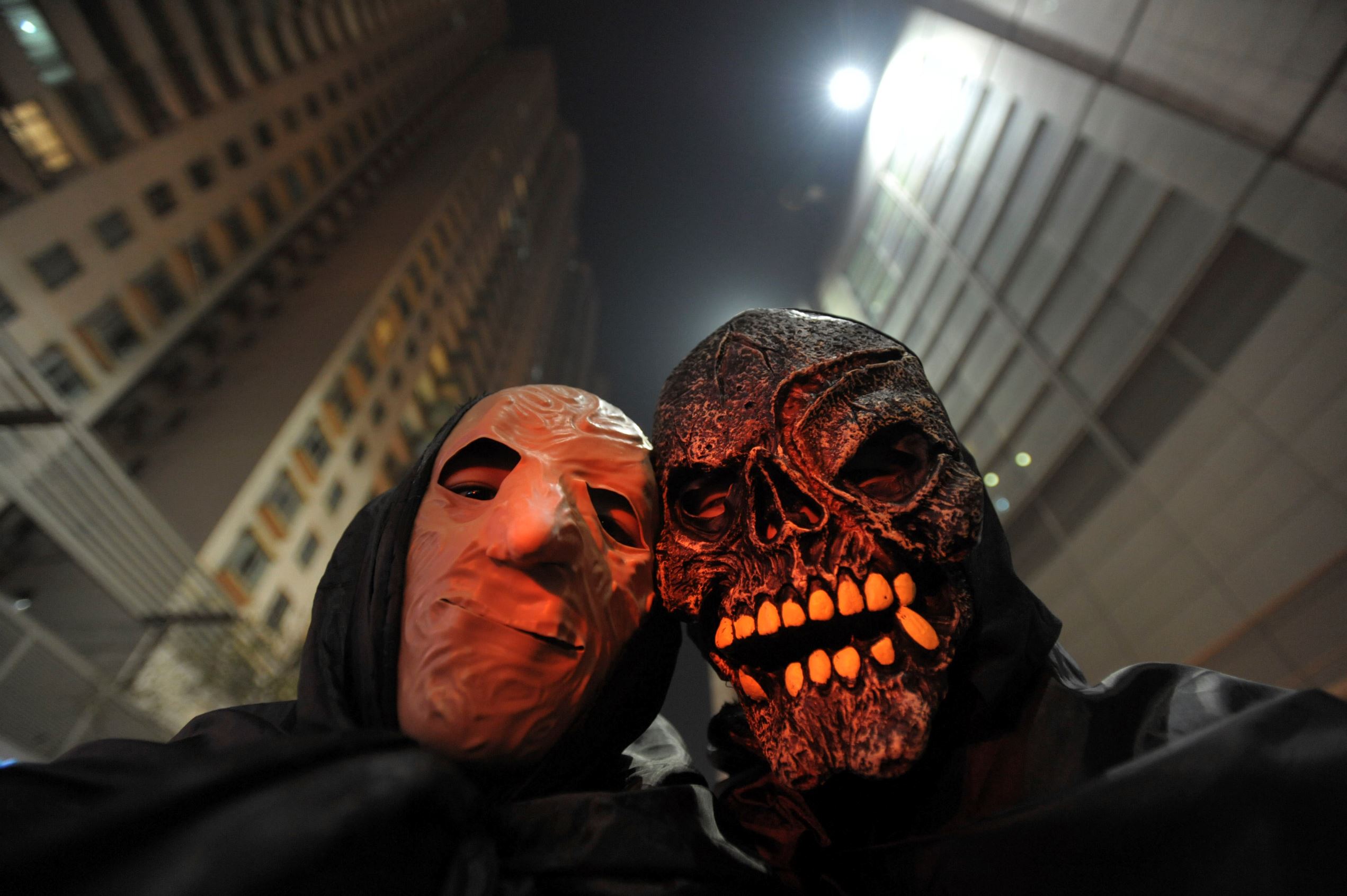 Slide 4 de 20: People wear masks as they celebrate Halloween in Wuhan, Hubei province,October 30,2010. (Photo by Jie Zhao/Corbis via Getty Images)