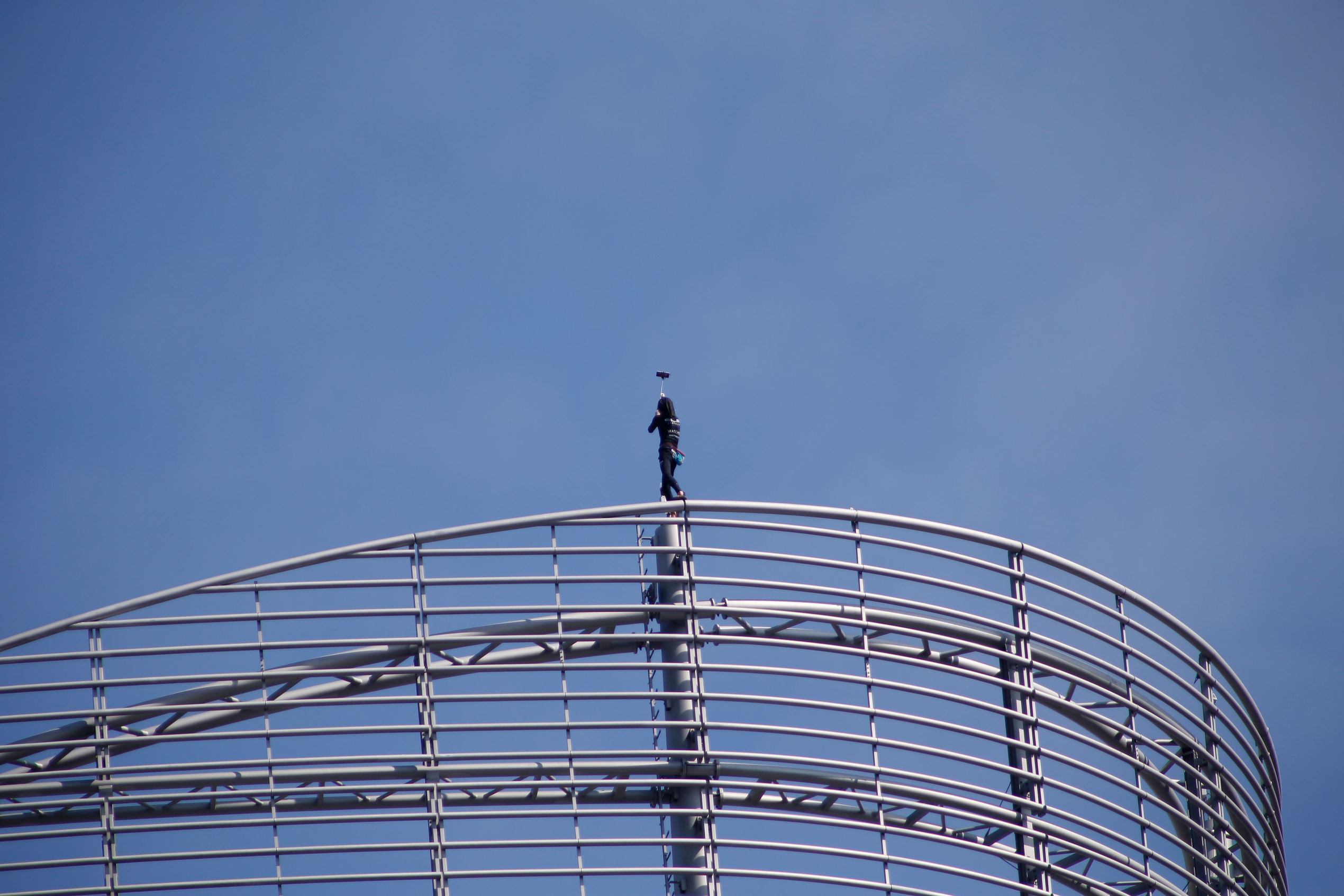 Alain Robert, a French urban climber aka Spiderman, takes a selfie as he stands on top of a building of La Defense business area, on August 31, 2016 in Courbevoie, near Paris.