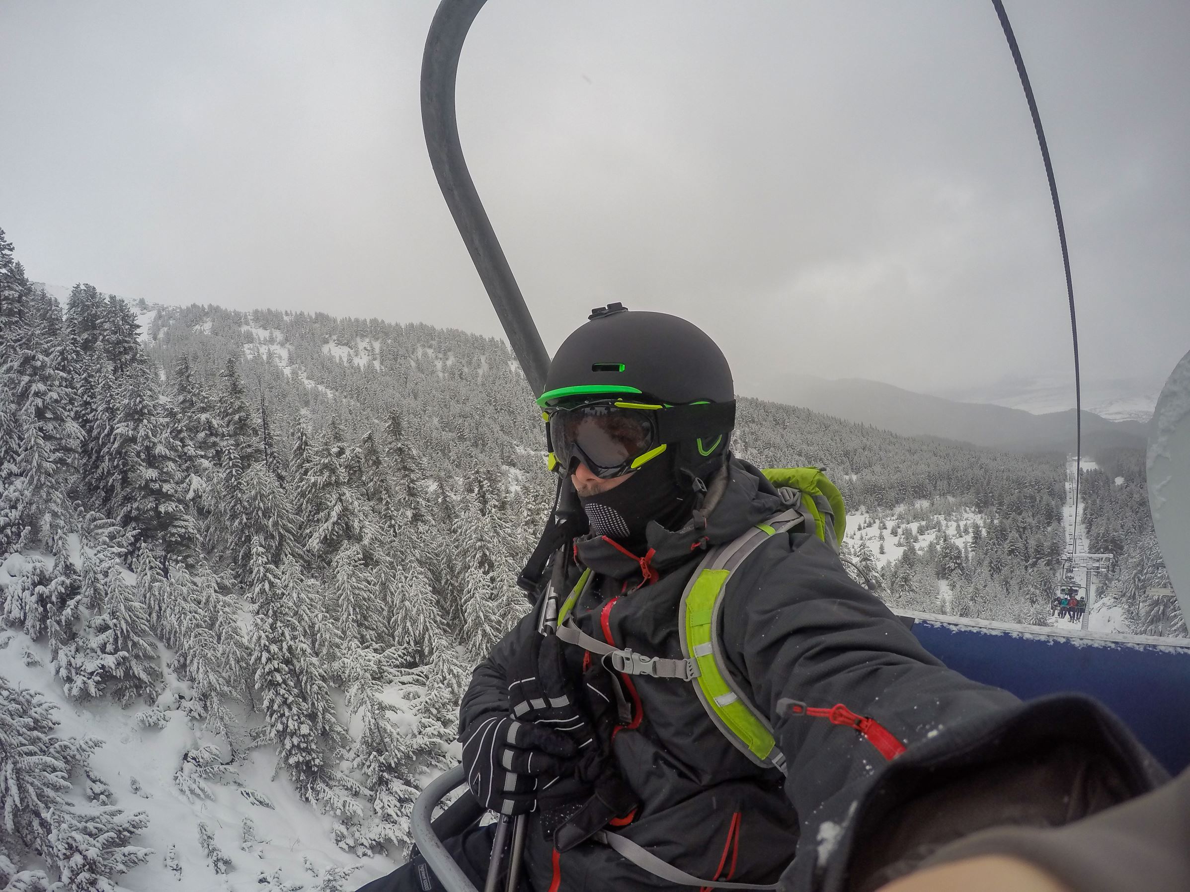 selfie on the chairlift alone , going skiing on a cold winter day