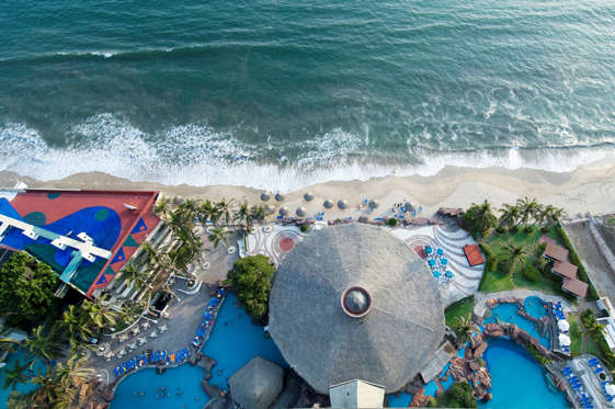 Aerial view of El Moro hotel with swimming pools, palapas, and beachfront, Mazatlan, Sinaloa, Mexico.
