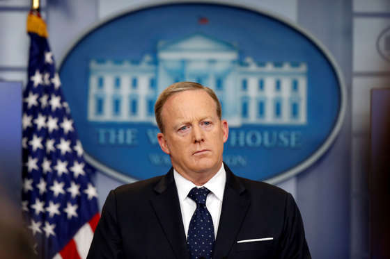 Slide 1 of 13: White House press secretary Sean Spicer listens to a reporter