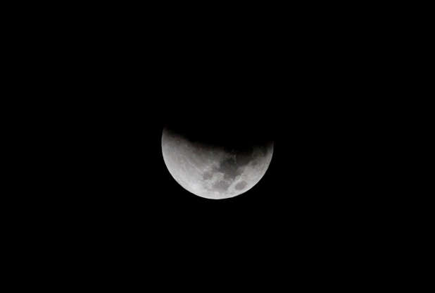 Slide 2 of 53: In this Monday, Sept. 28, 2015 photo, earth's shadow begins to obscure the view of a so-called supermoon during a total lunar eclipse over the Mediterranean Sea in Netanya, Israel. A team of Israeli engineers is the first to advance in an international competition sponsored by Google to send a privately-funded spacecraft to the moon, contest organizers announced Wednesday, Oct. 7. (AP Photo/Ariel Schalit)