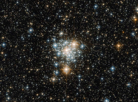 NGC 299 - ESA/Hubble and NASA Slide 76 of 86: It may be famous for hosting spectacular sights such as the Tucana Dwarf Galaxy and 47 Tucanae (heic1510), the second brightest globular cluster in the night sky, but the southern constellation of Tucana (The Toucan) also possesses a variety of unsung cosmic beauties. One such beauty is NGC 299, an open star cluster located within the Small Magellanic Cloud just under 200,000 light-years away. Open clusters such as this are collections of stars weakly bound by the shackles of gravity, all of which formed from the same massive molecular cloud of gas and dust. Because of this, all the stars have the same age and composition, but vary in their mass because they formed at different positions within the cloud. This unique property not only ensures a spectacular sight when viewed through a sophisticated instrument attached to a telescope such as Hubble’s Advanced Camera for Surveys, but gives astronomers a cosmic laboratory in which to study the formation and evolution of stars — a process that is thought to depend strongly on a star’s mass. Image credit: ESA/Hubble & NASA Text credit: European Space Agency