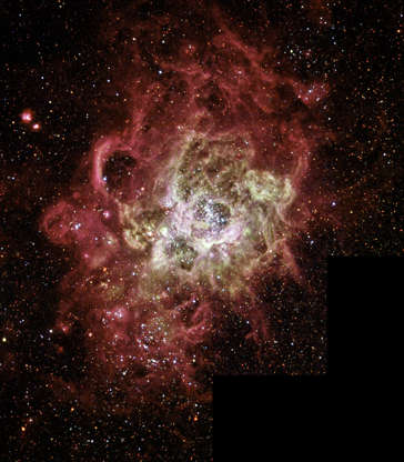 Slide 79 of 86: UNDATED PHOTO: This festively colorful nebula, called NGC 604, is one of the largest known seething cauldrons of star birth in a nearby galaxy. This star-birth region contains more than 200 brilliant blue stars within a cloud of glowing gases some 1,300 light-years across, nearly 100 times the size of the Orion Nebula. (Photo by NASA via Getty Images)