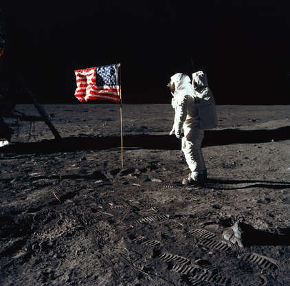Slide 68 of 86: 376713 03: (FILE PHOTO) Astronaut Edwin E. Aldrin, Jr., the lunar module pilot of the first lunar landing mission, stands next to a United States flag July 20, 1969 during an Apollo 11 Extravehicular Activity (EVA) on the surface of the Moon. The 30th anniversary of Apollo's moon landing is celebrated July 20, 1999. (Photo by NASA/Newsmakers)