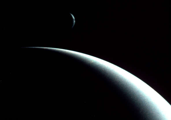 Slide 61 of 86: This dramatic view of the crescents of Neptune and Triton was acquired by Voyager II approximately 3 days, 6 and one-half hours after it's closest approach to Neptune (August 29, 1989). (Photo by Photo12/UIG/Getty Images)