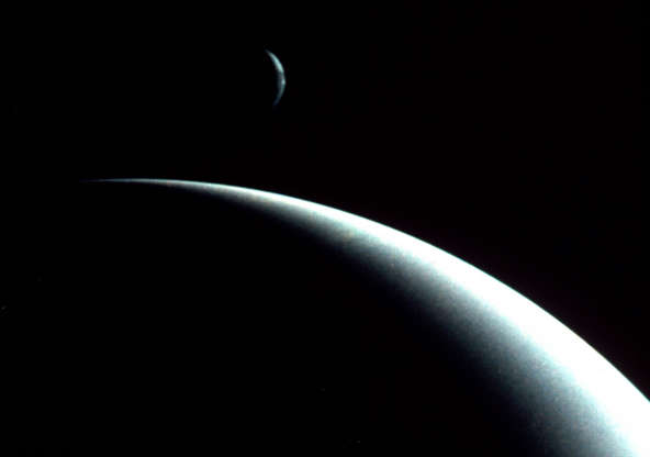 Neptune and Triton - Photo12/UIG/Getty Images Slide 61 of 86: This dramatic view of the crescents of Neptune and Triton was acquired by Voyager II approximately 3 days, 6 and one-half hours after it's closest approach to Neptune (August 29, 1989). (Photo by Photo12/UIG/Getty Images)