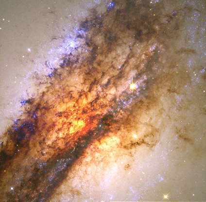 Slide 83 of 86: The image above only begins to describe Hubble's ability to amaze with both beauty and science. A massive black hole hidden at the center of nearby galaxy, Centaurus A, feeds on a smaller galaxy in a spectacular collision.