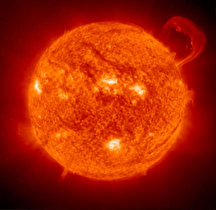 Slide 75 of 86: This Image of the sun taken by Extreme Ultraviolet Imaging Telescope (EIT) of the NASA and ESA operated The Solar and Heliospheric Observatory (SOHO) aircraft.Image of the sun taken by Extreme Ultraviolet Imaging Telescope (EIT) of the NASA and ESA operated The Solar and Heliospheric Observatory (SOHO) aircraft. (EIT) image of a huge, handle-shaped prominence was taken on Sept. 14,1999. Taken in the 304 angstrom wavelength, prominences are huge clouds of relatively cool dense plasma suspended in the Sun's hot, thin corona. At times, they can erupt, escaping the Sun's atmosphere.  Emission in this spectral line shows the upper chromosphere at a temperature of about 60,000 degrees K. Every feature in the image traces magnetic field structure. The hottest areas appear almost white, while the darker red areas indicate cooler temperatures.