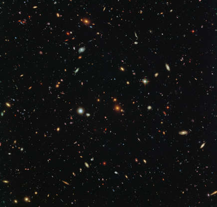 Abell 2744 - Judy Schmidt/NASA, ESA and the HST Frontier Fields team (STScI) Slide 84 of 86: Peering deep into the early universe, this picturesque parallel field observation from the NASA/ESA Hubble Space Telescope reveals thousands of colorful galaxies swimming in the inky blackness of space. A few foreground stars from our own galaxy, the Milky Way, are also visible. In October 2013 Hubble’s Wide Field Camera 3 (WFC3) and Advanced Camera for Surveys (ACS) began observing this portion of sky as part of the Frontier Fields program. This spectacular skyscape was captured during the study of the giant galaxy cluster Abell 2744, otherwise known as Pandora’s Box. While one of Hubble’s cameras concentrated on Abell 2744, the other camera viewed this adjacent patch of sky near to the cluster. Containing countless galaxies of various ages, shapes and sizes, this parallel field observation is nearly as deep as the Hubble Ultra-Deep Field. In addition to showcasing the stunning beauty of the deep universe in incredible detail, this parallel field — when compared to other deep fields — will help astronomers understand how similar the universe looks in different directions. Image credit: NASA, ESA and the HST Frontier Fields team (STScI), Acknowledgement: Judy Schmidt Text credit: European Space Agency