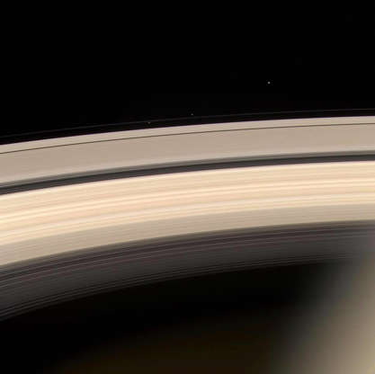 Slide 47 of 86: SPACE, SPACE: Saturn and its rings are prominently shown in this color image released by NASA 19 August, 2004, along with three of Saturn's smaller moons. From L-R they are: Prometheus, Pandora and Janus. Prometheus and Pandora are often called the 'F ring shepherds' as they control and interact with Saturn's interesting F ring, seen between them. This image was taken at a distance of 8.2 million kilometers (5.1 million miles) from Saturn. The Cassini-Huygens mission is a cooperative project of NASA, the European Space Agency and the Italian Space Agency. AFP PHOTO/NASA (Photo credit should read HO/AFP/Getty Images)