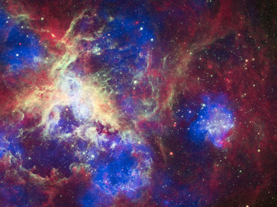 Tarantula Nebula - Barcroft Media/Getty Images Slide 39 of 86: UNSPECIFIED, APRIL 23: A new view of the Tarantula Nebula on April 23, 2012. To celebrate its 22nd anniversary in orbit, the Hubble Space Telescope released a dramatic new image of the star-forming region 30 Doradus, also known as the Tarantula Nebula because its glowing filaments resemble spider legs. A new image from all three of NASA's Great Observatories--Chandra, Hubble, and Spitzer--has also been created to mark the event. The nebula is located in the neighboring galaxy called the Large Magellanic Cloud, and is one of the largest star-forming regions located close to the Milky Way. At the center of 30 Doradus, thousands of massive stars are blowing off material and producing intense radiation along with powerful winds. The Chandra X-ray Observatory detects gas that has been heated to millions of degrees by these stellar winds and also by supernova explosions. These X-rays, colored blue in this composite image, come from shock fronts--similar to sonic booms--formed by this high-energy stellar activity. The Hubble data in the composite image, colored green, reveals the light from these massive stars along with different stages of star birth, including embryonic stars a few thousand years old still wrapped in cocoons of dark gas. Infrared emission data from Spitzer, seen in red, shows cooler gas and dust that have giant bubbles carved into them. These bubbles are sculpted by the same searing radiation and strong winds that comes from the massive stars at the center of 30 Doradus. PHOTOGRAPH BY Barcroft Media /Barcoft Media via Getty Images
