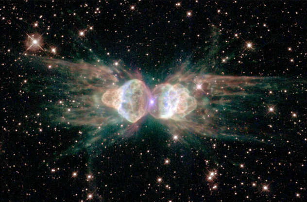 Slide 51 of 86: 385221 01: A Hubble Space Telescope image released February 1, 2001 of the so-called 'ant nebula' (Menzel 3, or Mz3) reveals the 'ant's' body as a pair of fiery lobes protruding from a dying star. The Hubble images directly challenge old ideas about the last stages in the lives of stars. By observing Sun-like stars as they approach their deaths, the Hubble Heritage image of Mz3, along with pictures of other planetary nebulae, shows that our Sun's fate probably will be more interesting, complex, and striking than astronomers imagined just a few years ago. (Photo by NASA/Newsmakers)