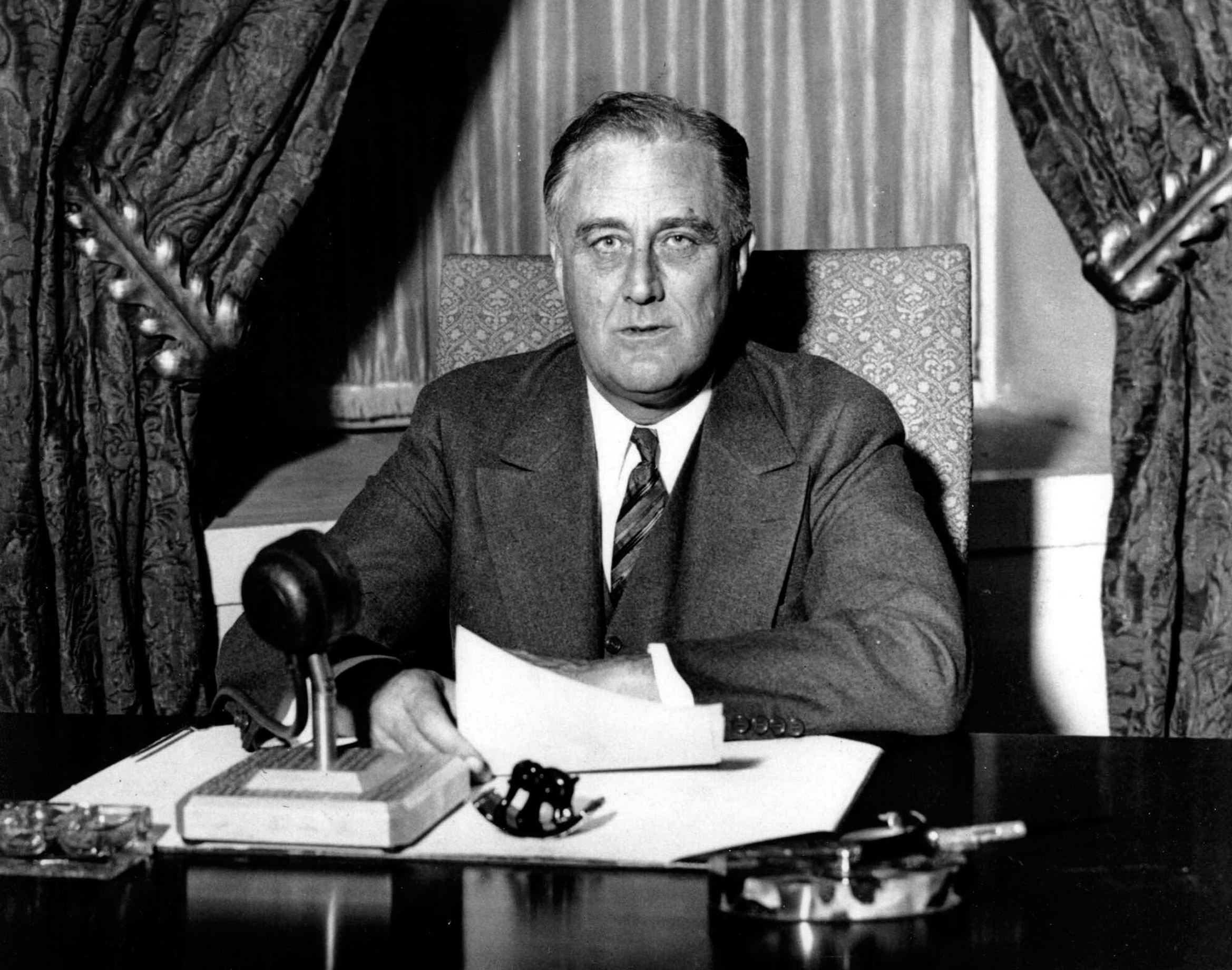 Slide 5 of 9: Image Caption: UNSPECIFIED - :: Franklin Delano Roosevelt (1882-1945), 32nd President of the United States of America 1933-1945, giving one of his 'fireside' broadcasts to the American nation during. (Photo by Universal History Archive/Getty Images)