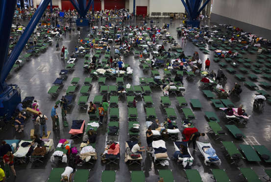 Harvey - Erich Schlegel/Getty Images Slide 3 of 119: Evacuees fill up cots at the George Brown Convention Center that has been turned into a shelter run by the American Red Cross to house victims of the high water from Hurricane Harvey on August 28, 2017 in Houston, Texas. Harvey, which made landfall north of Corpus Christi late Friday evening, is expected to dump upwards to 40 inches of rain in areas of Texas over the next couple of days.