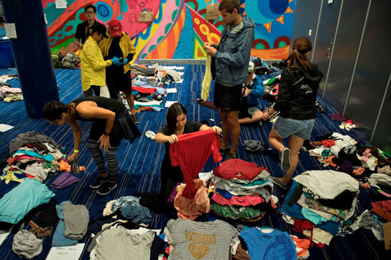 Harvey - Brendan Smialowski/AFP/Getty Images Slide 2 of 119: Volunteers sort through donated clothing at a shelter in the George R. Brown Convention Center during the aftermath of Hurricane Harvey on August 28, 2017 in Houston, Texas. Rescue teams in boats, trucks and helicopters scrambled Monday to reach hundreds of Texans marooned on flooded streets in and around the city of Houston before monster storm Harvey returns.