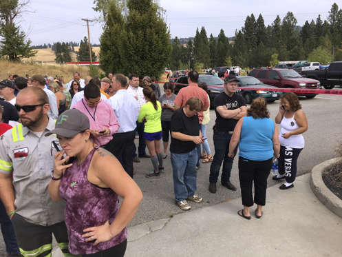 Parents gather in the parking lot behind Freeman High School in Rockford, Wash. to wait for their ki... - (Dan Pelle/The Spokesman-Review via AP) Parents gather in the parking lot behind Freeman High School in Rockford, Wash. to wait for their kids, after a deadly shooting at the high school Wednesday, Sept. 13, 2017.