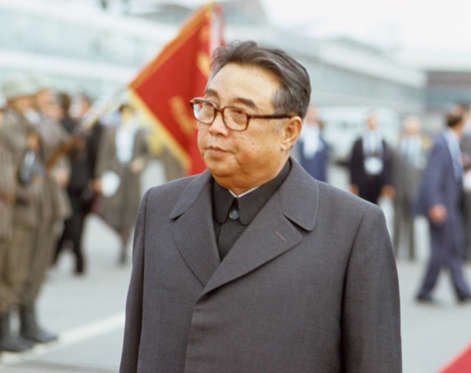 Slide 3 of 20: Kim il Sung walks on a red carpet and observes a military line