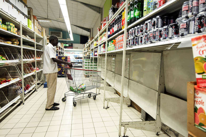 Slide 46 of 46: A man pushes a shoppping trolley in a supermarket where all packs of bottled water have been sold, in Pointe-a-Pitre, on the French overseas island of Guadeloupe on September 4, 2017, as part of preparations for arrival of Hurricane Irma.