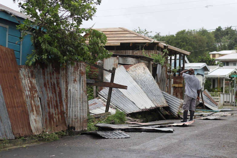 Slide 27 of 31: A man surveys the wreckage on his property after the passing of Hurricane Irma, in St. John's, Antigua and Barbuda, Wednesday, Sept. 6, 2017. Heavy rain and 185-mph winds lashed the Virgin Islands and Puerto Rico's northeast coast as Irma, the strongest Atlantic Ocean hurricane ever measured, roared through Caribbean islands on its way to a possible hit on South Florida. (AP Photo/Johnny Jno-Baptiste)