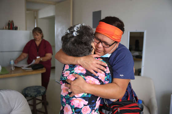 Slide 2 of 162: Mercedes Perez is hugged by Brenda Francisco, RN, of the First Medical Relief team as they give her aide at the Pedro America Pagan de Colon assisted living facility in the aftermath of Hurricane Maria on October 1, 2017 in San Juan, Puerto Rico.