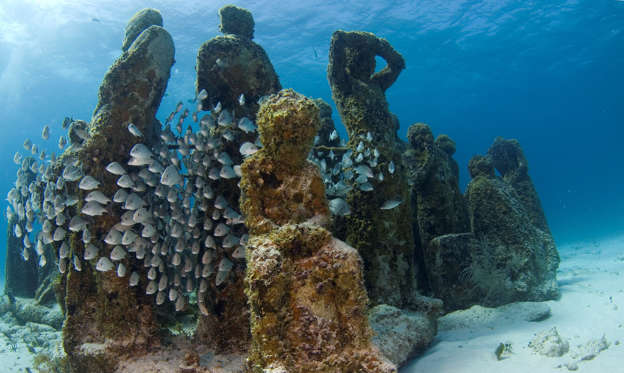 Slide 1 de 26: Largest underwater museum located in Cancun Mexico caribbean sea, sculptures made out of real people to drive away tourism from natural reefs and create an artificial reef. (Photo by: Luis Javier Sandoval/VW Pics/UIG via Getty Images)