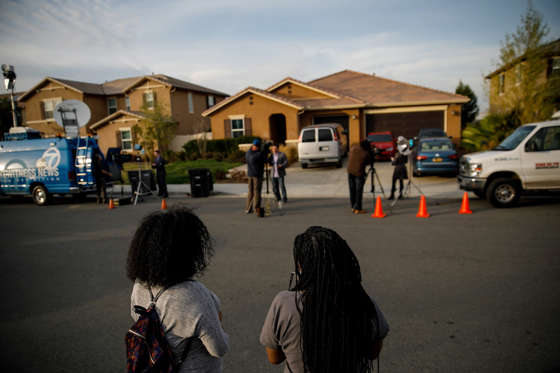 Slide 1 of 8: Neighbors stand outside the day after a Perris husband and wife are in custody on suspicion of torture and child abuse at a home on 100 Block of Muir Woods Road, in Perris, Calif., on Jan. 15, 2018.