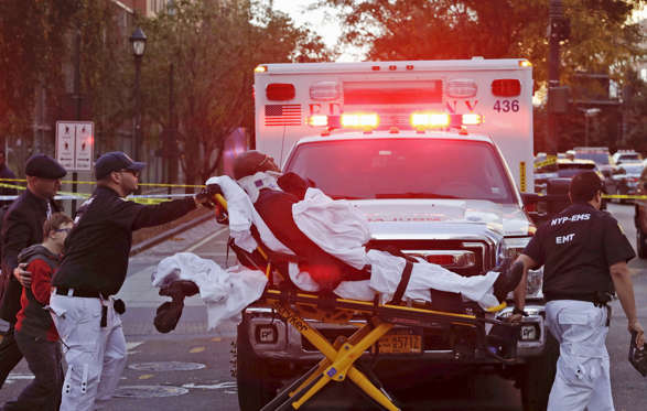 Emergency personnel transport a man on a stretcher after a motorist drove onto a busy bicycle path n... - Mark Lennihan/AP Photos Manhattan,medics take victim to hospital