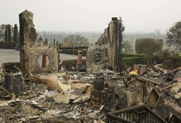 FILE - In this Oct. 10, 2017 file photo, the remains of the Signorello Estate winery continue to smolder in Napa, Calif.