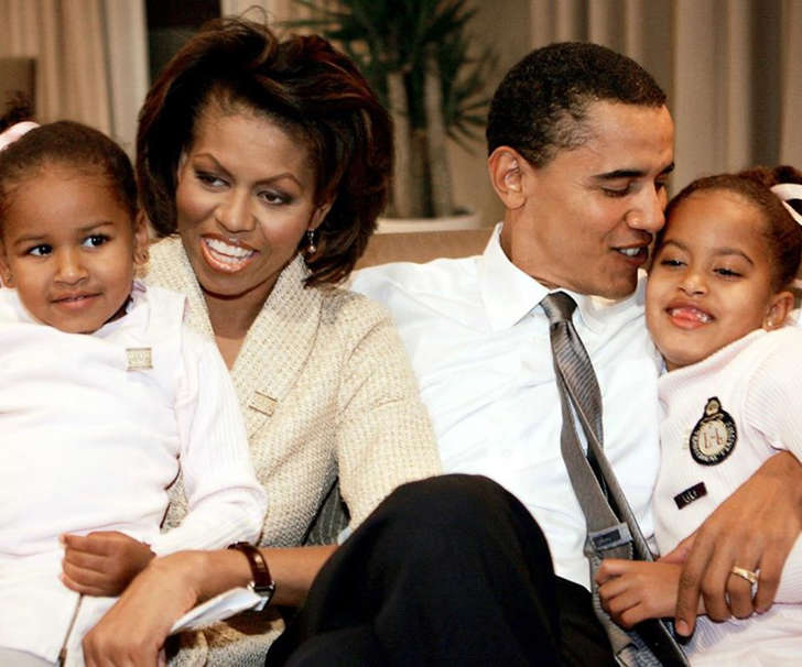 Michelle Obama et al. sitting posing for the camera: Here proud parents Michelle and Barack can be seen at the beginning of their journey in the public eye with their tiny daughters, Sasha and Malia.
