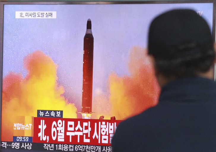 A man watches a TV news program showing a file image of a missile launch conducted by North Korea, at the Seoul Railway Station in Seoul, South Korea, Sunday, Oct. 16, 2016.