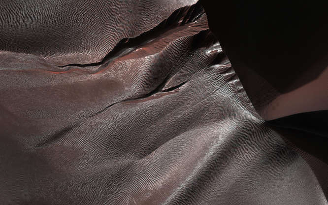Slide 85 of 86: Gullies on Martian sand dunes, like these in Matara Crater, have been very active, with many flows in the last ten years. The flows typically occur when seasonal frost is present. In this image from NASA's Mars Reconnaissance Orbiter we see frost in and around two gullies, which have both been active before. (View this observation to see what these gullies looked like in 2010.) There are no fresh flows so far this year, but HiRISE will keep watching. The map is projected here at a scale of 50 centimeters (19.7 inches) per pixel. [The original image scale is 50.3 centimeters (19.8 inches) per pixel (with 2 x 2 binning); objects on the order of 151 centimeters (59.4 inches) across are resolved.] North is up. The University of Arizona, Tucson, operates HiRISE, which was built by Ball Aerospace & Technologies Corp., Boulder, Colorado. NASA's Jet Propulsion Laboratory, a division of Caltech in Pasadena, California, manages the Mars Reconnaissance Orbiter Project for NASA's Science Mission Directorate, Washington.