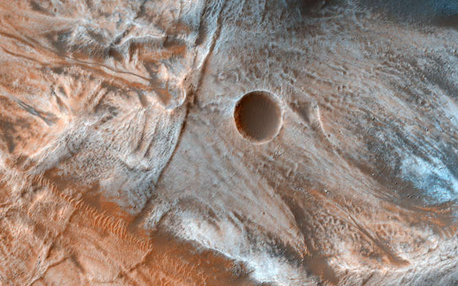 Mars - JPL-Caltech/Univ. of Arizona/NASA/Handout via Reuters Slide 23 of 86: A view of the surface of Mars released by NASA on March 7, 2017, shows viscous, lobate flow features commonly found at the bases of slopes in the mid-latitudes of Mars, and are often associated with gullies. These are bound by ridges that resemble terrestrial moraines, suggesting that these deposits are ice-rich, or may have been ice-rich in the past. NASA/JPL-Caltech/Univ. of Arizona/Handout via REUTERS ATTENTION EDITORS - THIS IMAGE WAS PROVIDED BY A THIRD PARTY