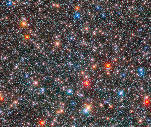 Slide 86 of 86: This Hubble Space Telescope image of a sparkling jewel box full of stars captures the heart of our Milky Way galaxy. The image is a composite of exposures taken in near-infrared and visible light with Hubble’s Wide Field Camera 3. The observations are part of two Hubble surveys: the Galactic Bulge Treasury Program and the Sagittarius Window Eclipsing Extrasolar Planet Search.