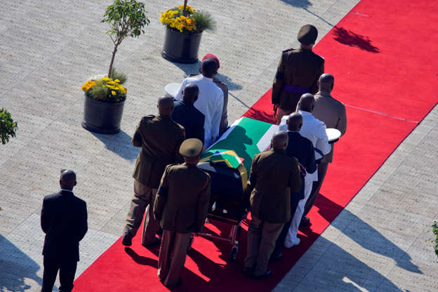 The flag draped coffin carrying the remains of anti-apartheid icon Winnie Madikizela-Mandela arrives for the funeral ceremony in Soweto, South Africa's Orlando stadium Saturday, April 14, 2018. Madikizela-Mandela died April 2, 2018, at the age of 81. (AP Photo/Jerome Delay)