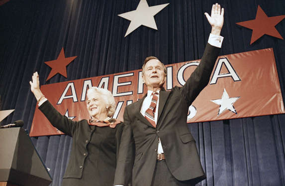 Slide 11 of 28: President-elect George H.W. Bush, right, and his wife Barbara Bush, wave to the crowd at a victory celebration rally, Tuesday, Nov. 8, 1988, Houston, Texas.