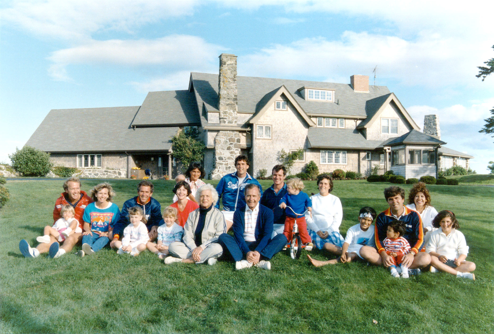 Slide 8 of 28: Portrait of the Bush family in front of their Kennebunkport, Maine August 24, 1986. BACK ROW: Margaret holding daughter Marshall, Marvin Bush, Bill LeBlond. FRONT ROW: Neil Bush holding son Pierce, Sharon, George W. Bush holding daughter Barbara, Laura Bush holding daughter Jenna, Barbara Bush, George Bush, Sam LeBlond, Doro Bush Lebond, George P.(jeb's son), Jeb Bush holding son Jebby, Columba Bush, and Noelle Bush.