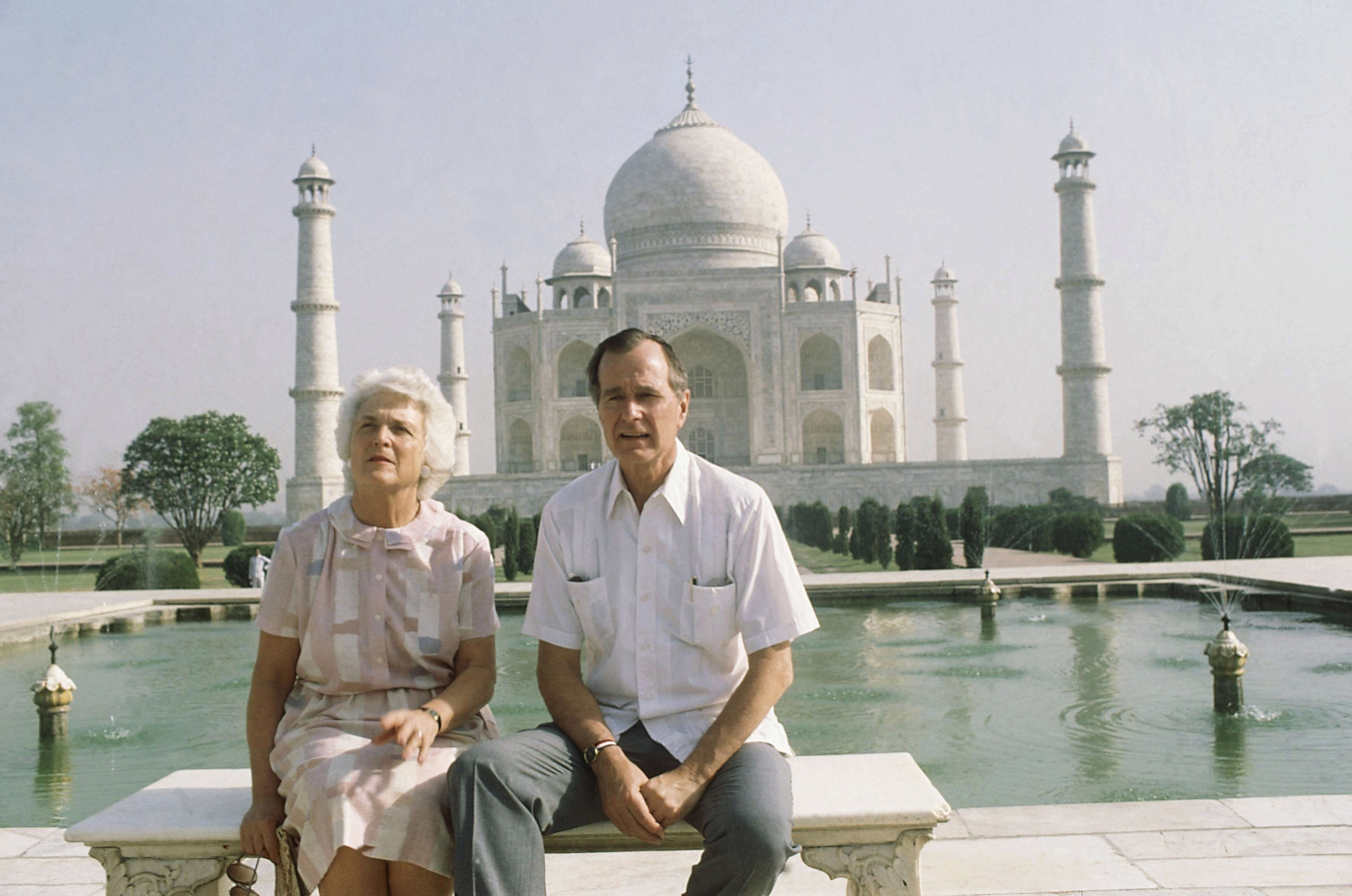 Slide 9 of 28: U.S. Vice President George H. W. Bush, right, and his wife Barbara Bush pose in front of the Taj Mahal, the 17th century monument to love was built by a Mughal Emperor Sahajahan in memory of his beloved queen who bore 14 children, Saturday, May 13, 1984, Agra, India.