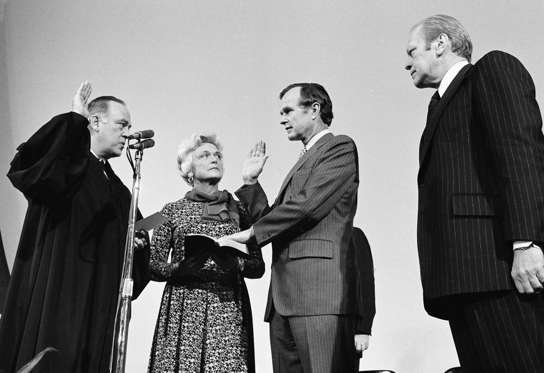 Slide 6 of 28: George Bush is sworn in as new director of the Central Intelligence Agency by Supreme Court Associate Justice Potter Stewart, left, as Mrs Barbara Bush and President Gerald Ford, at right, look on at CIA headquarters in Langley, Va., January 30, 1976.
