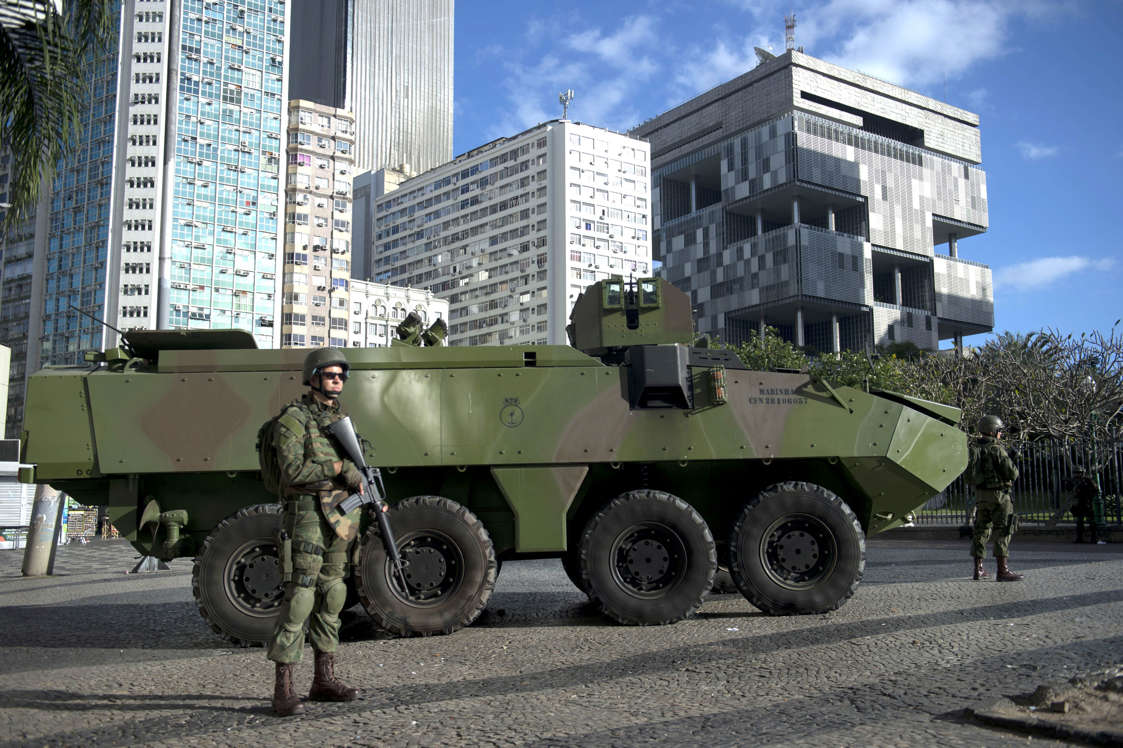 Slide 42 of 51: TOPSHOT - Brazilian marines with armoured personnel carriers (APC) take positions in downtown Rio de Janeiro, Brazil, on July 29, 2017. Brazil has mobilized some 8,500 soldiers to Rio de Janeiro state to fight organized crime and a spike in street violence. President Michel Temer signed a decree allowing the use of the armed forces in Rio de Janeiro state, the official government gazette announced. / AFP PHOTO / Mauro PIMENTEL (Photo credit should read MAURO PIMENTEL/AFP/Getty Images)