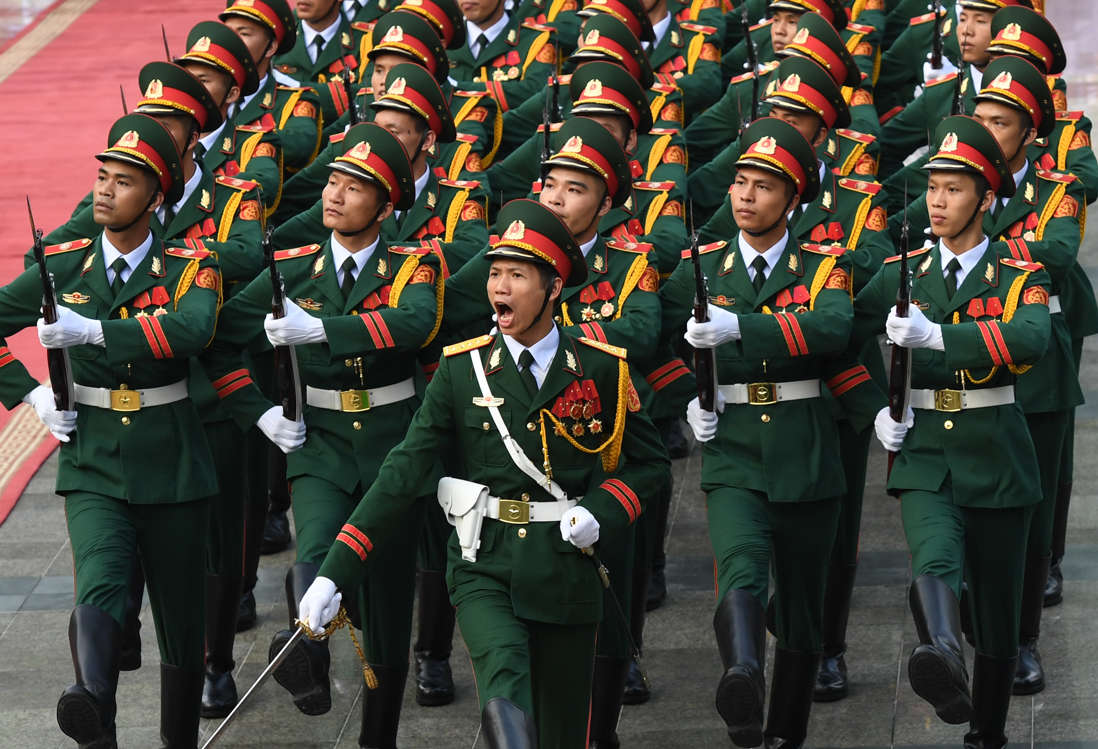 Slide 30 of 51: Vietnamese soldiers parade during a welcoming ceremony for Chinese President Xi Jinping at the presidential palace in Hanoi on November 12, 2017. / AFP PHOTO / POOL / HOANG DINH Nam (Photo credit should read HOANG DINH NAM/AFP/Getty Images)