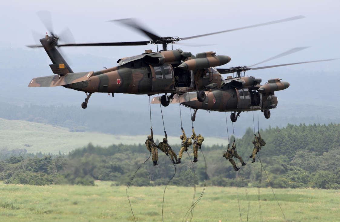 Slide 47 of 51: Japan Ground Self-Defense Force troops descend from helicopters during an annual live-fire exercise at the Higashi-Fuji firing range in Gotemba, at the foot of Mount Fuji in Shizuoka prefecture on August 24, 2017. The annual drill involves some 2,400 personnel, 80 tanks and armoured vehicles and some 20 aircraft and helicopters. / AFP PHOTO / Toshifumi KITAMURA (Photo credit should read TOSHIFUMI KITAMURA/AFP/Getty Images)
