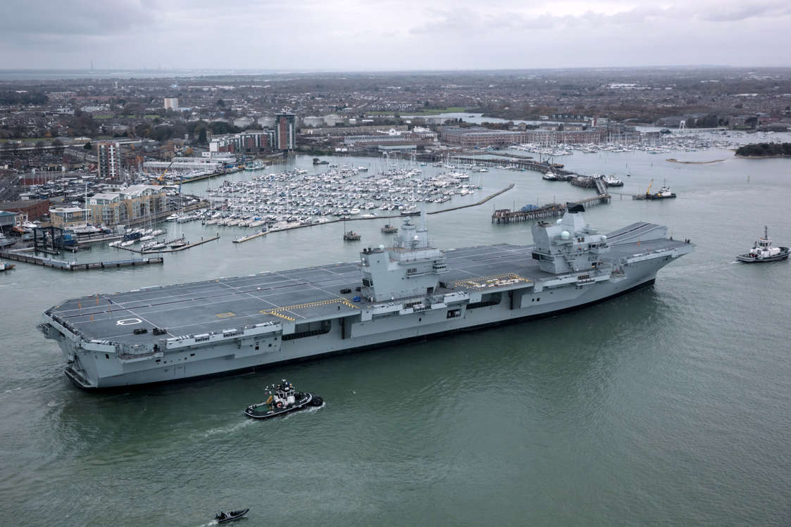 Slide 44 of 51: PORTSMOUTH, ENGLAND - NOVEMBER 21: HMS Queen Elizabeth sails into her home port of Portsmouth Naval Base following sea trials and ahead of being formally commissioned into the Royal Navy later next month, on November 21, 2017 in Portsmouth, England. HMS Queen Elizabeth is the lead ship in the new Queen Elizabeth class of supercarriers. Weighing in at 65,000 tonnes she is the largest warship deployed by the British Royal Navy. She is planned to be in service by 2020 and with a second ship, HMS Prince of Wales, to follow. (Photo by Matt Cardy/Getty Images)